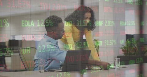 Diverse Coworkers Analyzing Stock Market Data in Modern Office