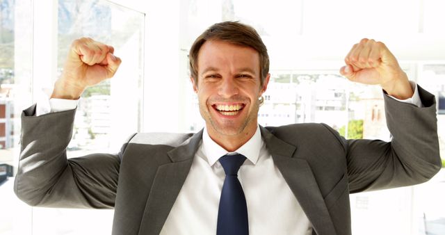 Businessman Celebrating Success with Raised Fists - Download Free Stock Images Pikwizard.com