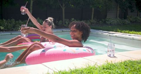 Joyful Women Enjoying Refreshing Poolside Gathering