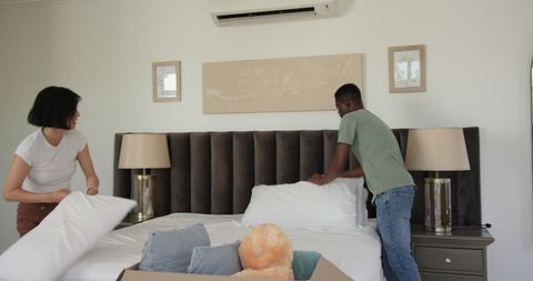 Couple Organizing Bedroom After Moving into New Home