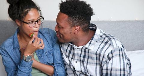 Multiracial couple celebrating anniversary with joyful smiles