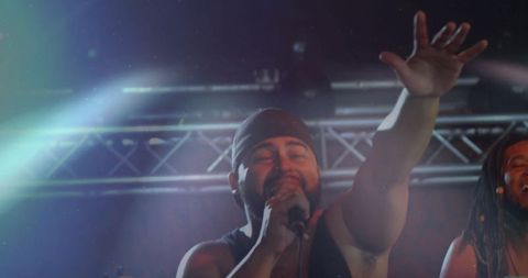 Energetic Male Vocalist Performing Live with Vibrant Stage Lighting