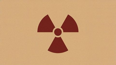 Stylized red radiation hazard symbol on brown background