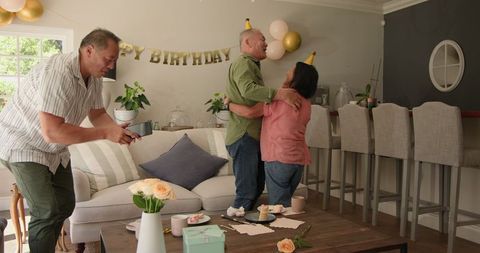Senior Couple Celebrating Birthday with Joy and Laughter at Home