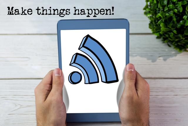 Hands holding tablet displaying WiFi icon and motivational text 'Make Things Happen!', resting on wooden desk. Can be used for illustrating themes like motivation, technology in everyday use, modern communication and productivity.