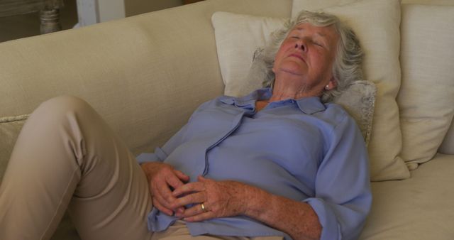 Tired caucasian senior woman sleeping on the couch at home - Download Free Stock Photos Pikwizard.com