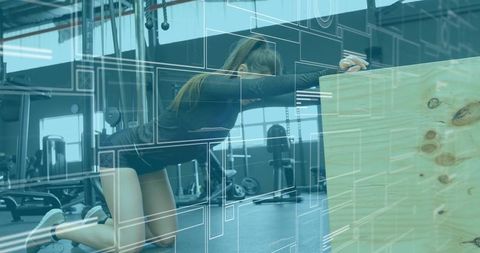 Athletic woman stretching with plyometric box in gym