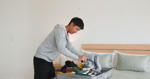 Man organizing clothes at home