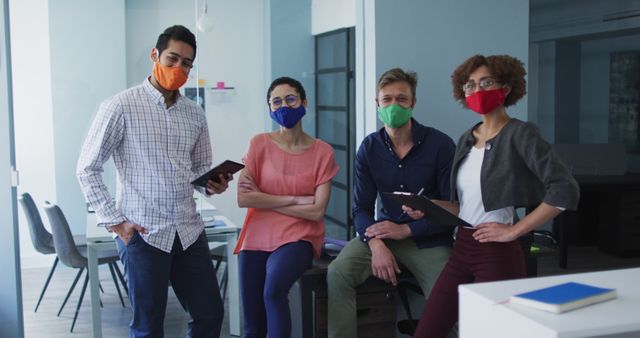 Diverse team wearing protective masks standing in modern office - Download Free Stock Images Pikwizard.com