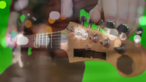 Guitar Tuning with Bokeh and Green Chroma Backdrop