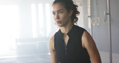 Focused Woman Taking Break During Intense Gym Workout