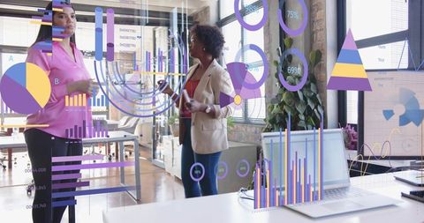 Businesswomen Analyzing Data with Holographic Charts in Modern Office