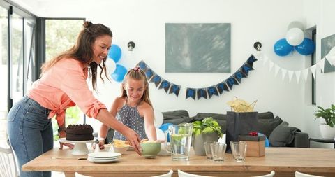 Mother and Daughter Setting Up Birthday Party Celebration