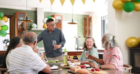 Senior Friends Celebrating Together at Home with Joy and Laughter