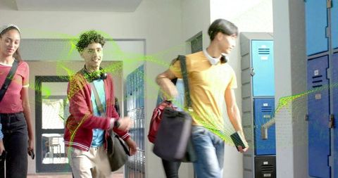 High school students walking past blue lockers carrying backpacks and wearing headphones