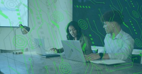 Colleagues collaborating on laptops with green circuit overlay for technology meeting