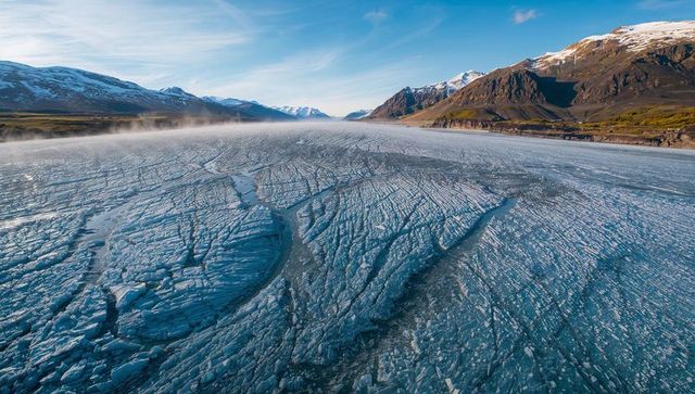 Ethereal Arctic Glacier with Cracked Ice and Rising Mist