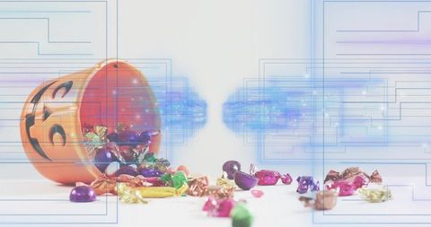 Tipping jack-o'-lantern bucket spilling foil-wrapped halloween candies with digital overlay