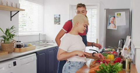 Happy Couple Preparing Vegetables in Modern Kitchen