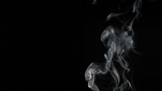 This video showcases white smoke swirling elegantly against a black background. The ethereal curls and wisps create a sense of mystery and elegance. It can be used effectively for depicting themes of haze, abstract concepts, or adding a surreal element to designs.