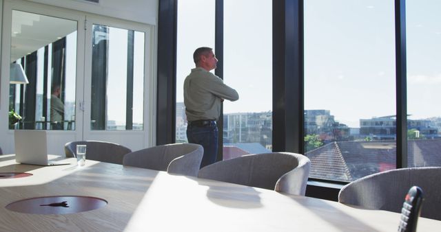 Businessman reflecting while looking out office window - Download Free Stock Images Pikwizard.com