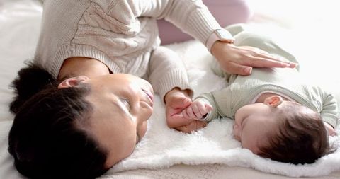 Loving Mother and Baby Lying Together in Gentle Light