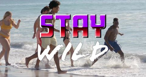 Group running through shallow surf wearing swimwear with stay wild graphic beach fun