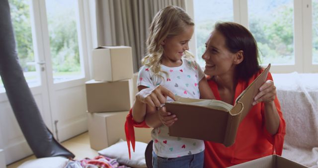 Mother and Daughter Unpacking Boxes in New Home - Download Free Stock Images Pikwizard.com