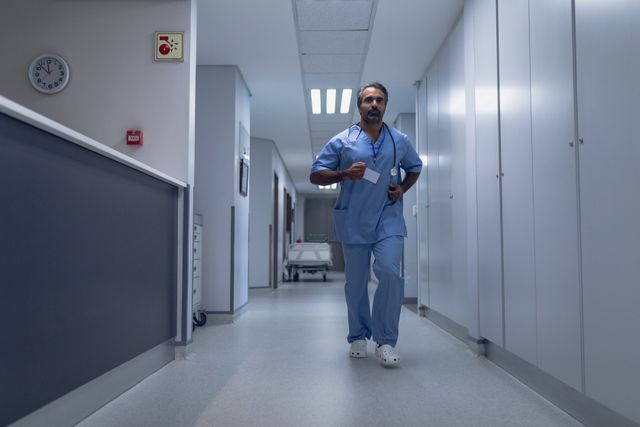 Mature male doctor running in the corridor at hospital