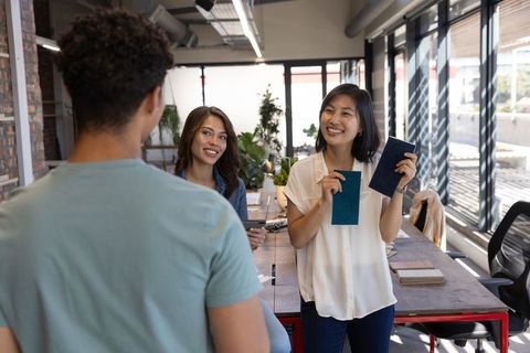 Design Team Collaborating with Fabric Swatches and Tablet