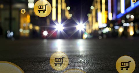 Digital shopping carts overlaying city street at night