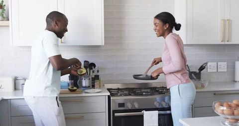 Happy Couple Cooking Breakfast in Modern Kitchen Together