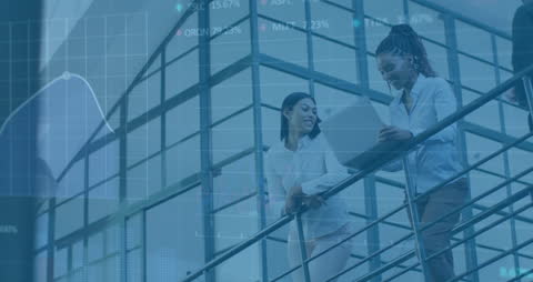 Businesswomen Discussing on Stairs with Financial Stock Data Overlay
