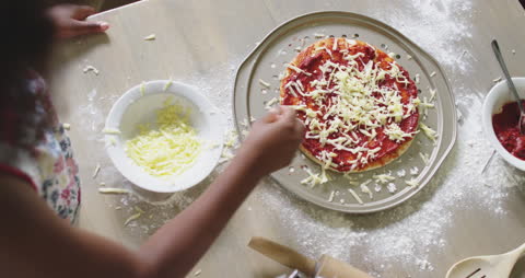 Child Making Homemade Pizza Adding Cheese with Guidance
