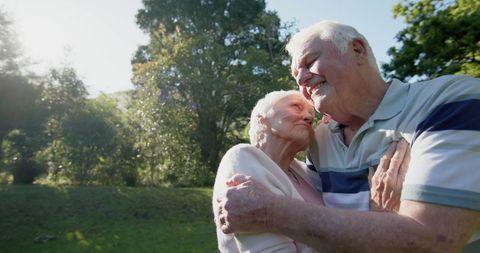 Loving Senior Couple Embracing in Sunny Garden