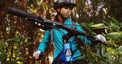 Female Cyclist Exploring Forest on Mountain Bike