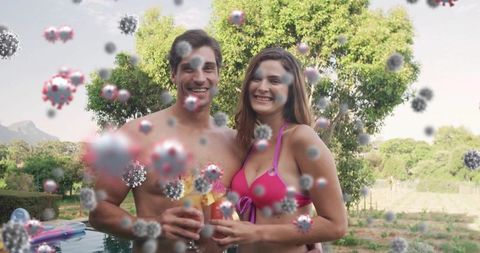 Smiling Couple at Poolside Surrounded by Virus Spheres