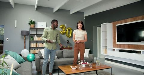 Couple Cleaning After Birthday Party with Decorations