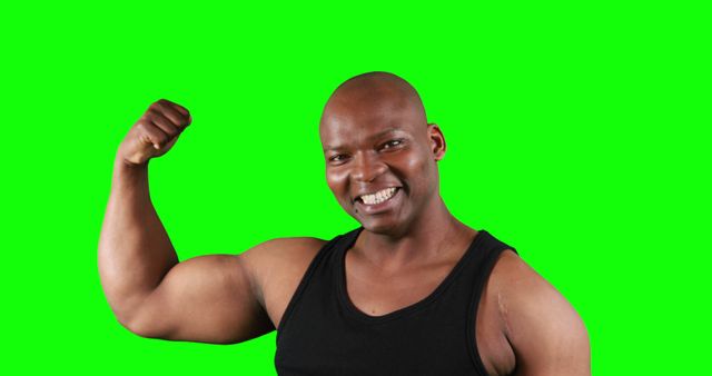 Smiling Man Flexing Arm Muscles in Black Tank Top with Green Screen Backdrop - Download Free Stock Images Pikwizard.com