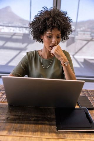 African american woman using modern technology in office setting