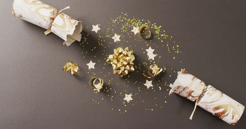 Christmas crackers with festive star decorations on dark background