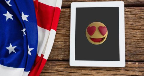 Heart-Eyes Emoji on Tablet Next to American Flag on Wooden Surface - Download Free Stock Images Pikwizard.com