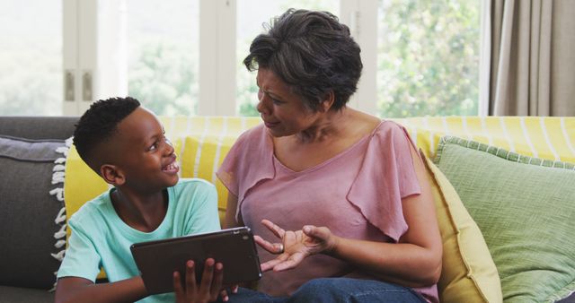 Grandmother and Grandson Using Tablet on Sofa at Home - Download Free Stock Images Pikwizard.com