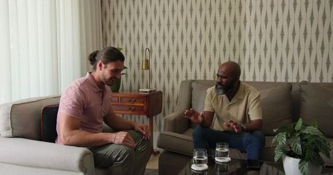 Two men having serious conversation in living room