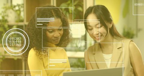 Diverse Colleagues Analyzing Business Data on Laptop in Modern Office