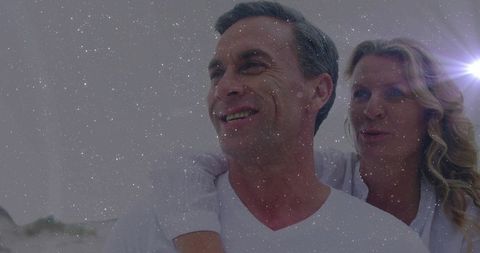 Smiling Couple Enjoying Beach Piggyback Ride Under Starry Skies
