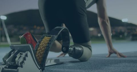 Paralympic Athlete on Running Track Preparing to Sprint