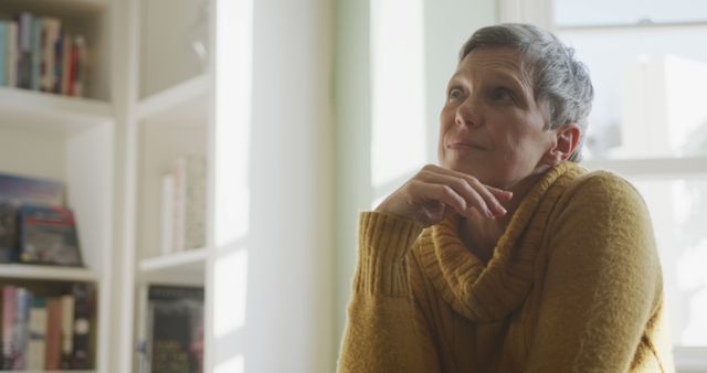 Thoughtful Older Woman in Cozy Sweater Looking Out Window - Download Free Stock Images Pikwizard.com