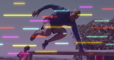 Athletic Man Leaping Over Obstacle Outdoors with Light Bars Overlay