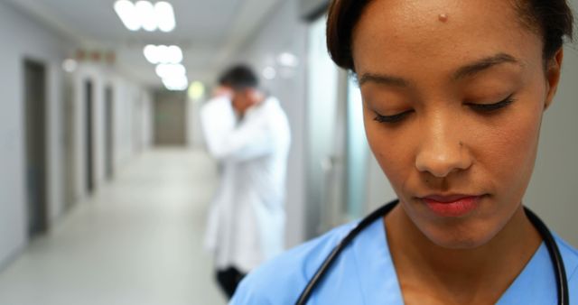 Female Nurse with Downcast Expression in Hospital Setting - Download Free Stock Images Pikwizard.com